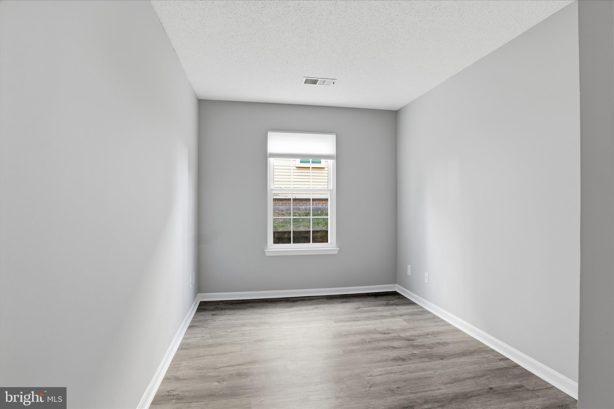 12002 Golf Ridge Court Fairfax, VA 22033 - Photo 14 of 43 a view of an empty room with wooden floor and a window