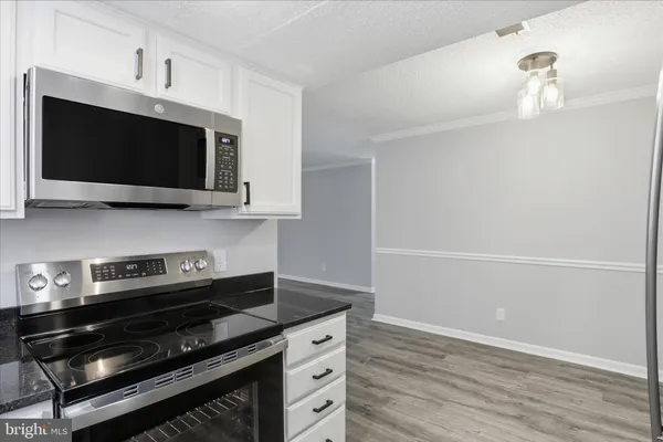 a kitchen with stainless steel appliances a stove a microwave and cabinets