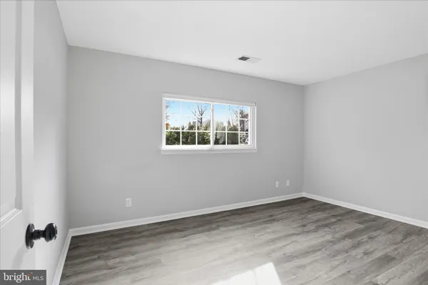 a view of a room with wooden floor and window