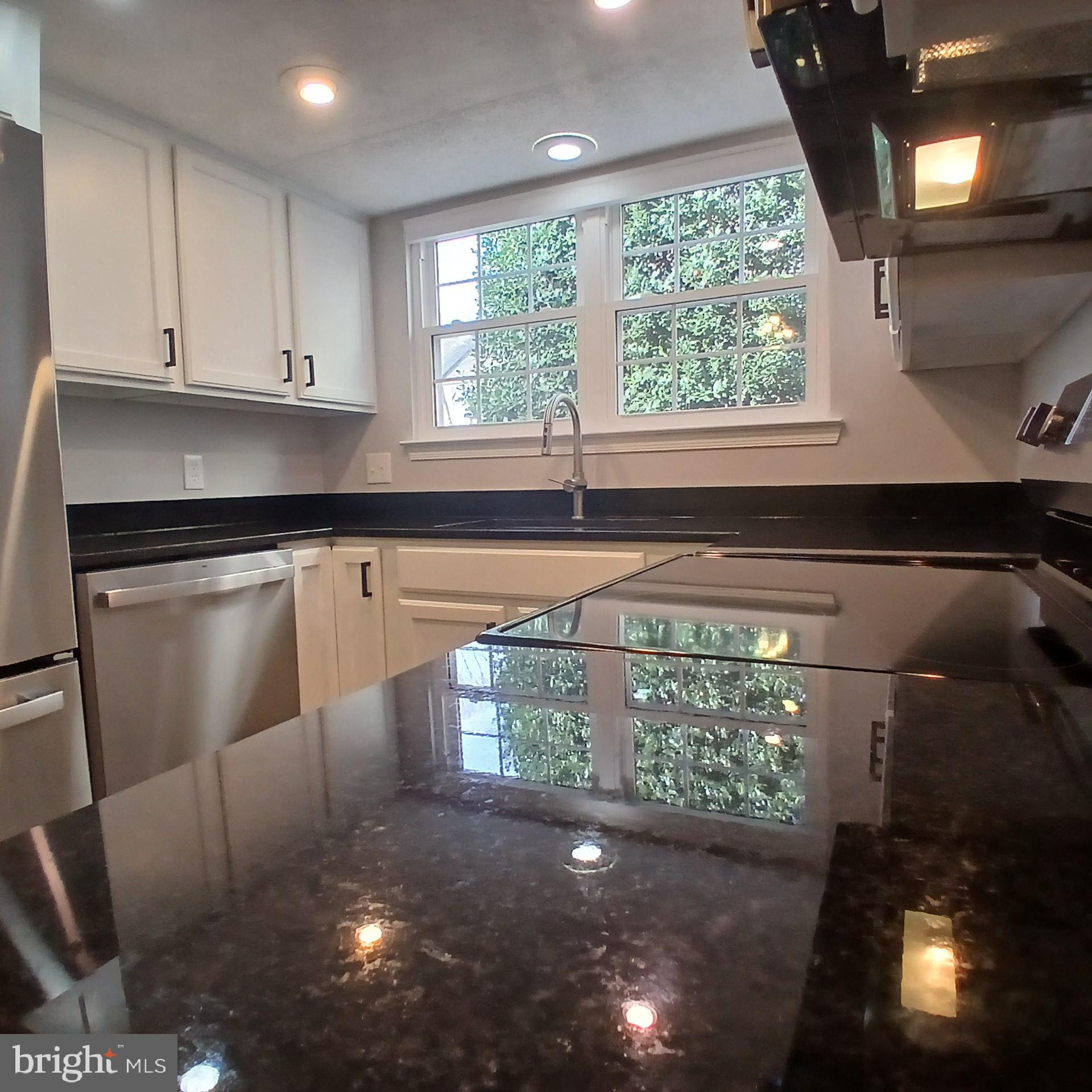 12002 Golf Ridge Court Fairfax, VA 22033 - Photo 2 of 43 a kitchen with granite countertop a stove a sink and a window