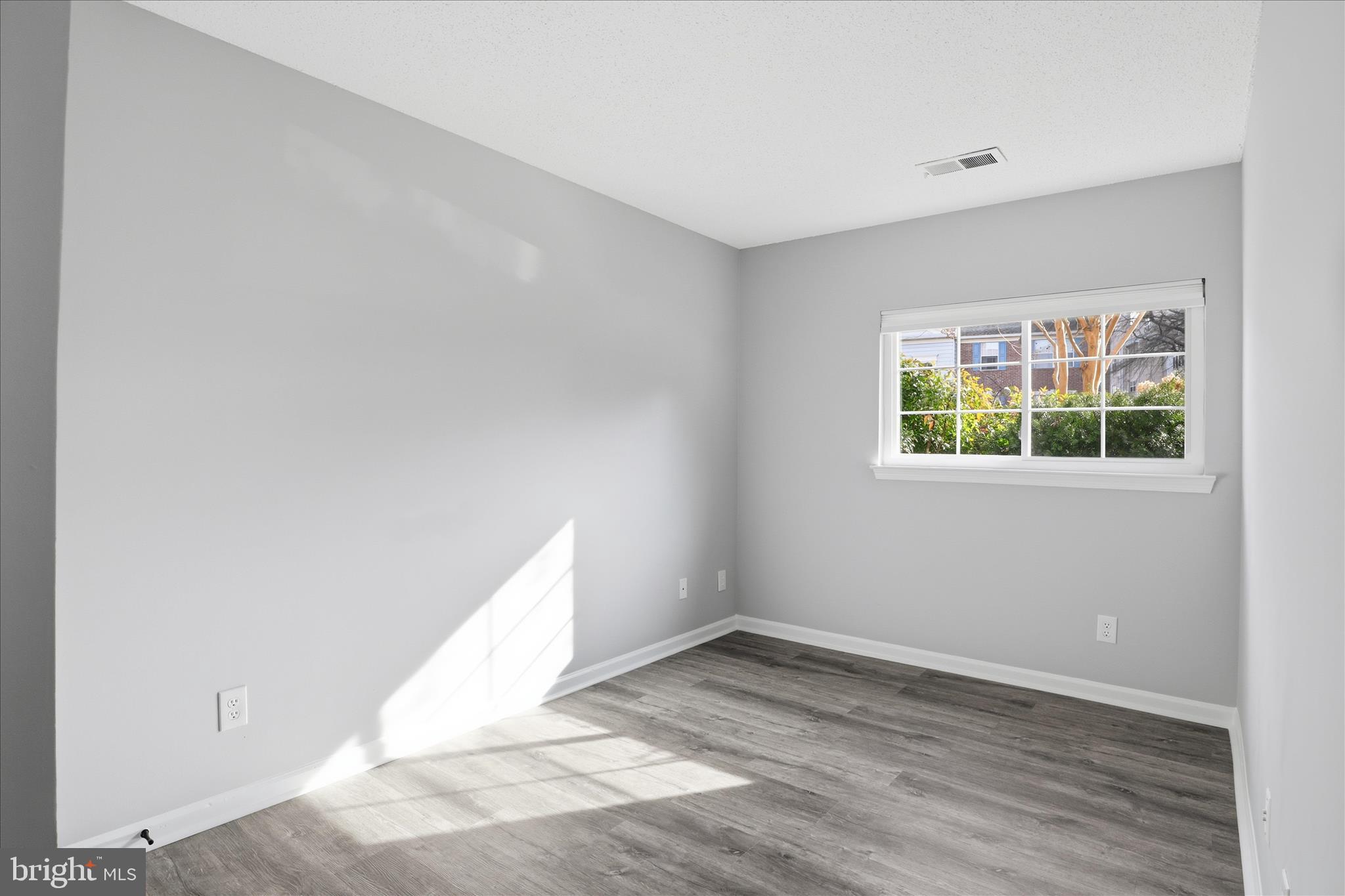 12002 Golf Ridge Court Fairfax, VA 22033 - Photo 23 of 43 an empty room with wooden floor and windows