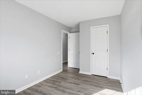 a view of an empty room and wooden floor