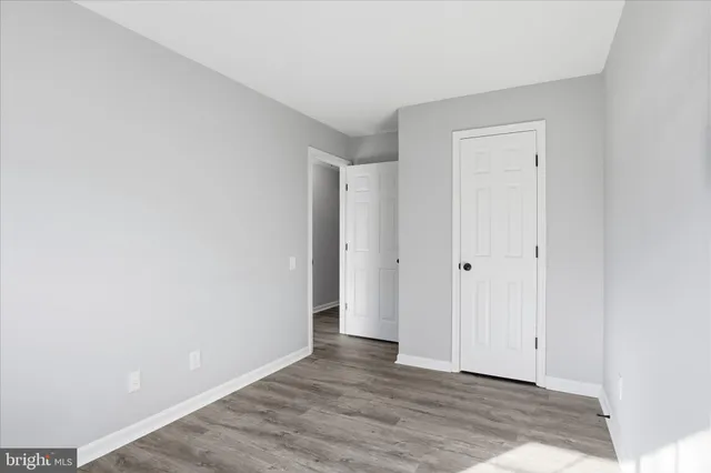 a view of an empty room and wooden floor