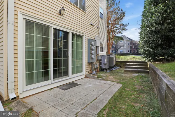 a view of a house with a large window and wooden fence