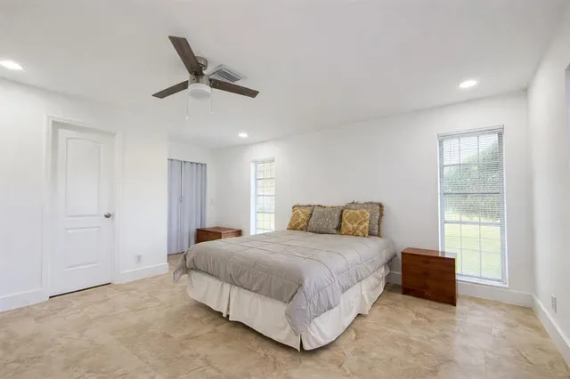 a bedroom with a bed and a ceiling fan