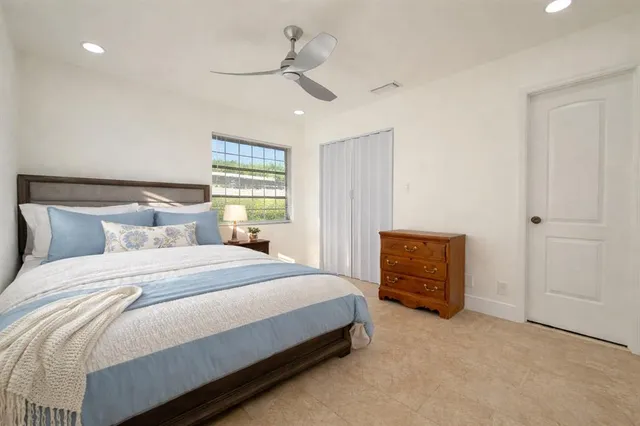 a bedroom with a bed and a dresser