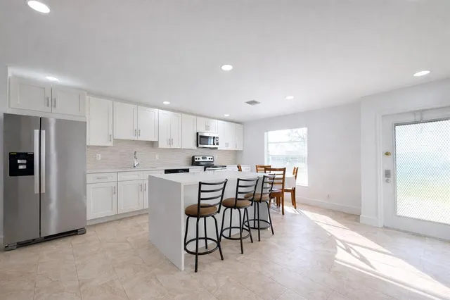 a kitchen with a table and chairs in it