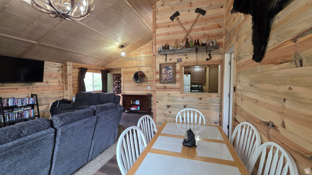 5782 Pineview Loop, Unit 921 Kamas, UT 84036 - Photo 12 of 29 Interior space featuring natural wood paneling throughout, a vaulted ceiling, and a dining area with a tile-top table