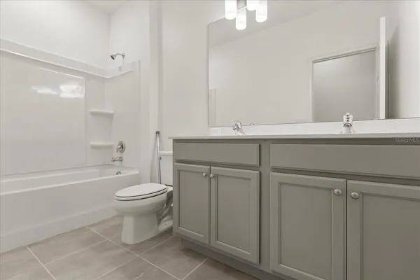 an empty room with a cabinet and mirrors