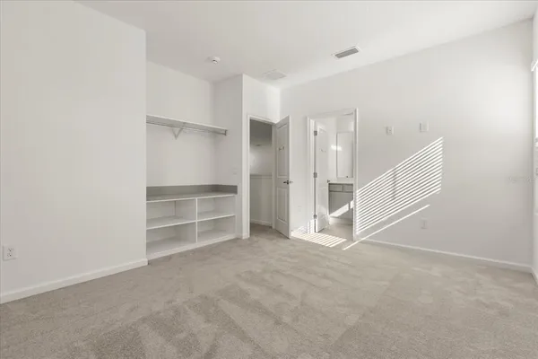 a living room with stainless steel appliances furniture a fireplace and a flat screen tv