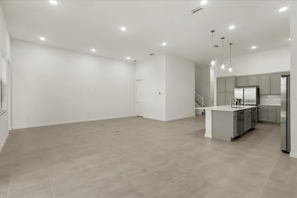 a large kitchen with kitchen island granite countertop a large counter top and sink