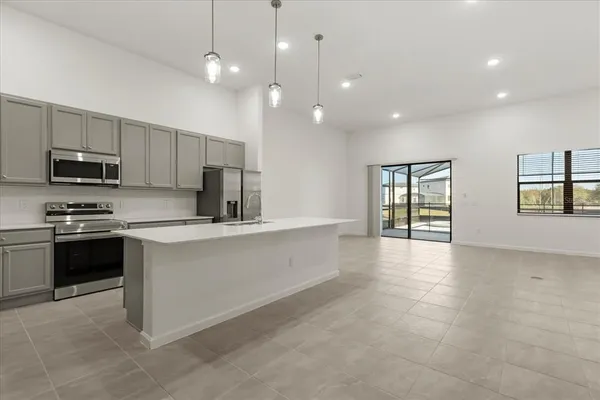 a kitchen with granite countertop a sink a stove and cabinets
