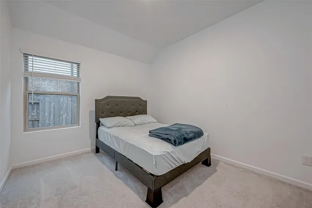 a bedroom with a bed and window