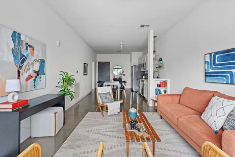 a living room with furniture and wooden floor