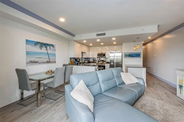 a living room with furniture and kitchen view