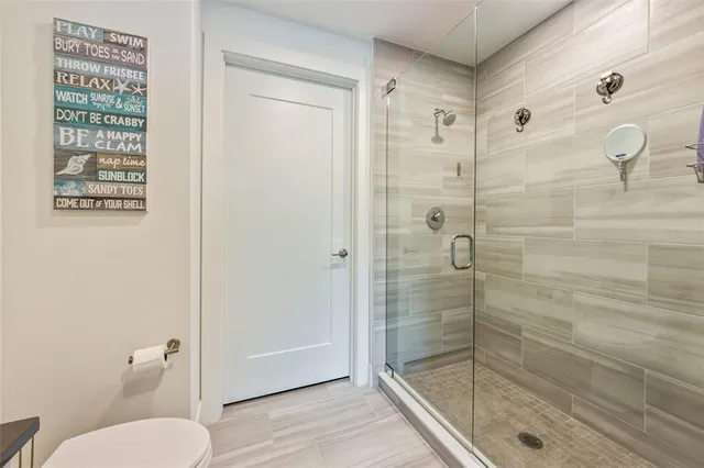 a bathroom with a shower a toilet and a sink