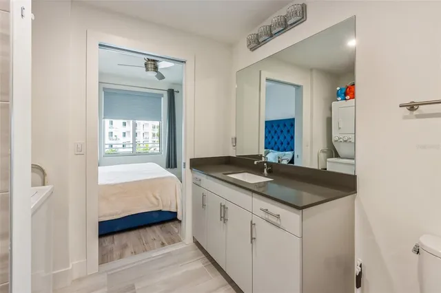 a en suite bathroom with a granite countertop sink and a mirror