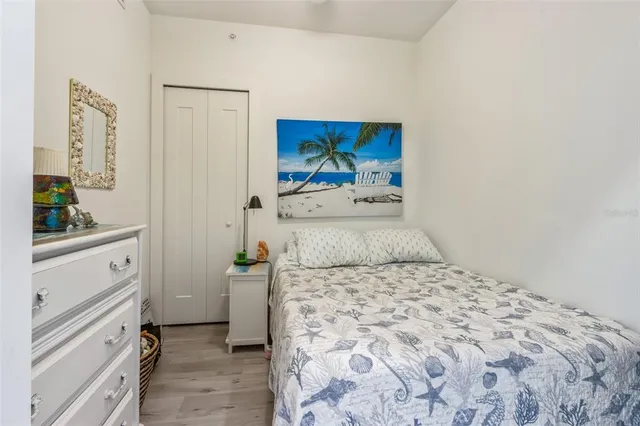 a bedroom with a bed and a dresser in it