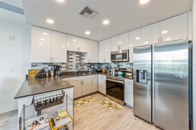 a kitchen with a refrigerator and a sink