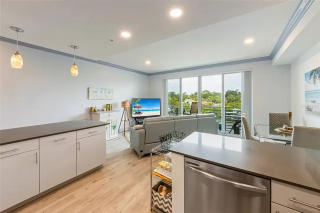 a kitchen with sink cabinets and wooden floor