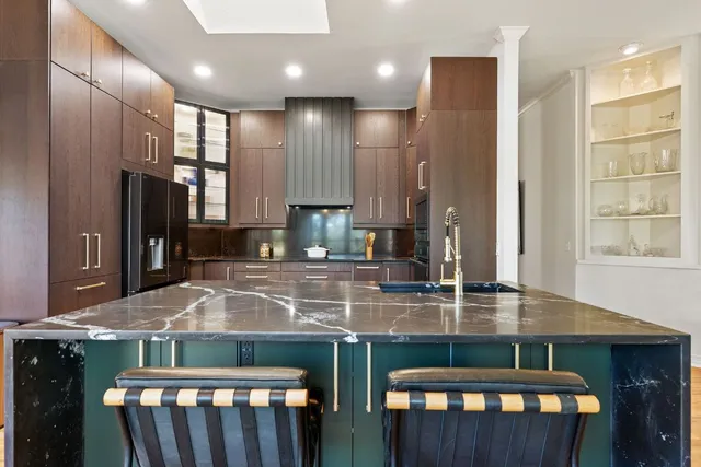 a kitchen with granite countertop counter space a sink appliances and a window