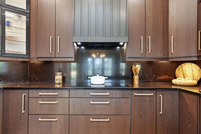 a kitchen with stainless steel appliances granite countertop a sink refrigerator and cabinets
