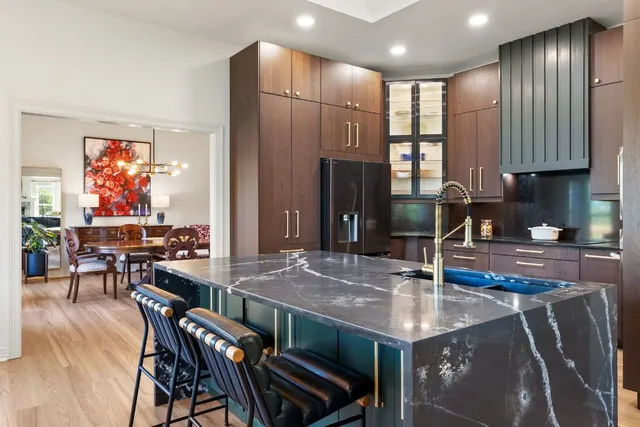 a kitchen with stainless steel appliances granite countertop a refrigerator sink and cabinets