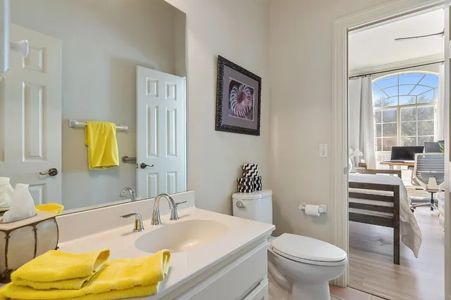 a kitchen with stainless steel appliances a table chairs and a refrigerator