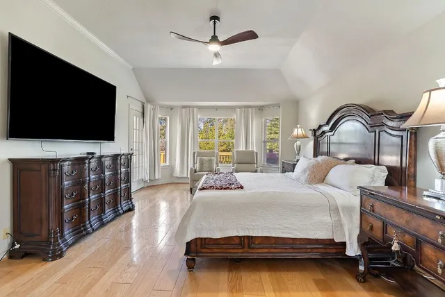 a bedroom with a large bed and a window