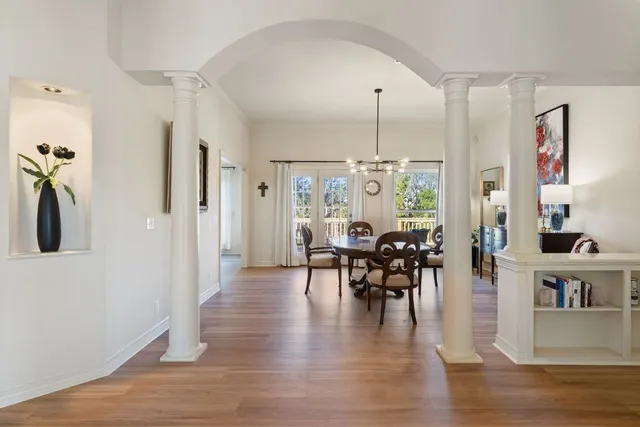a view of a a dining room with furniture window and wooden floor