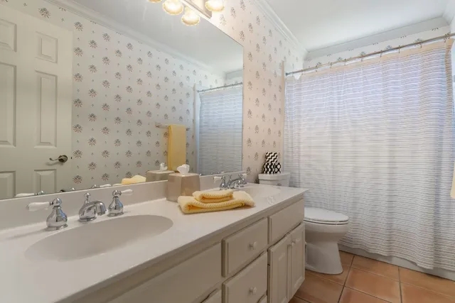 a bedroom with a bed a window and painting on the wall