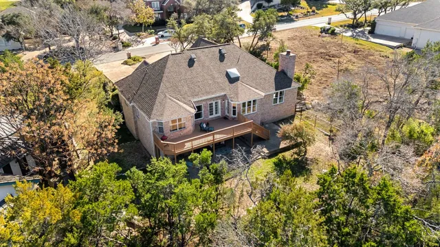 an aerial view of a house with a yard