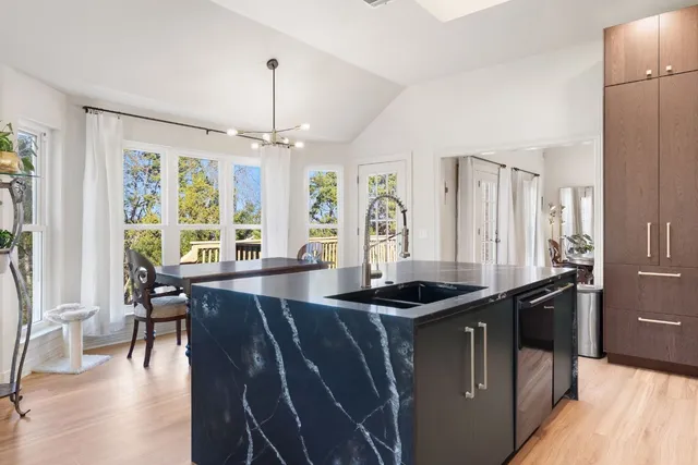 a view of kitchen with stainless steel appliances granite countertop lots of counter top space