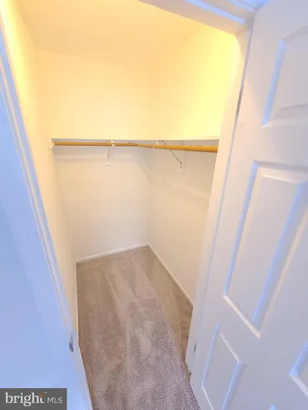 a view of closet and wooden floor