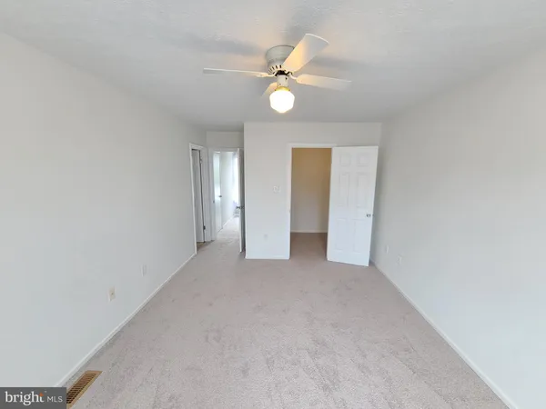 a view of an empty room with a fan