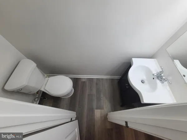 a bathroom with a sink mirror and toilet