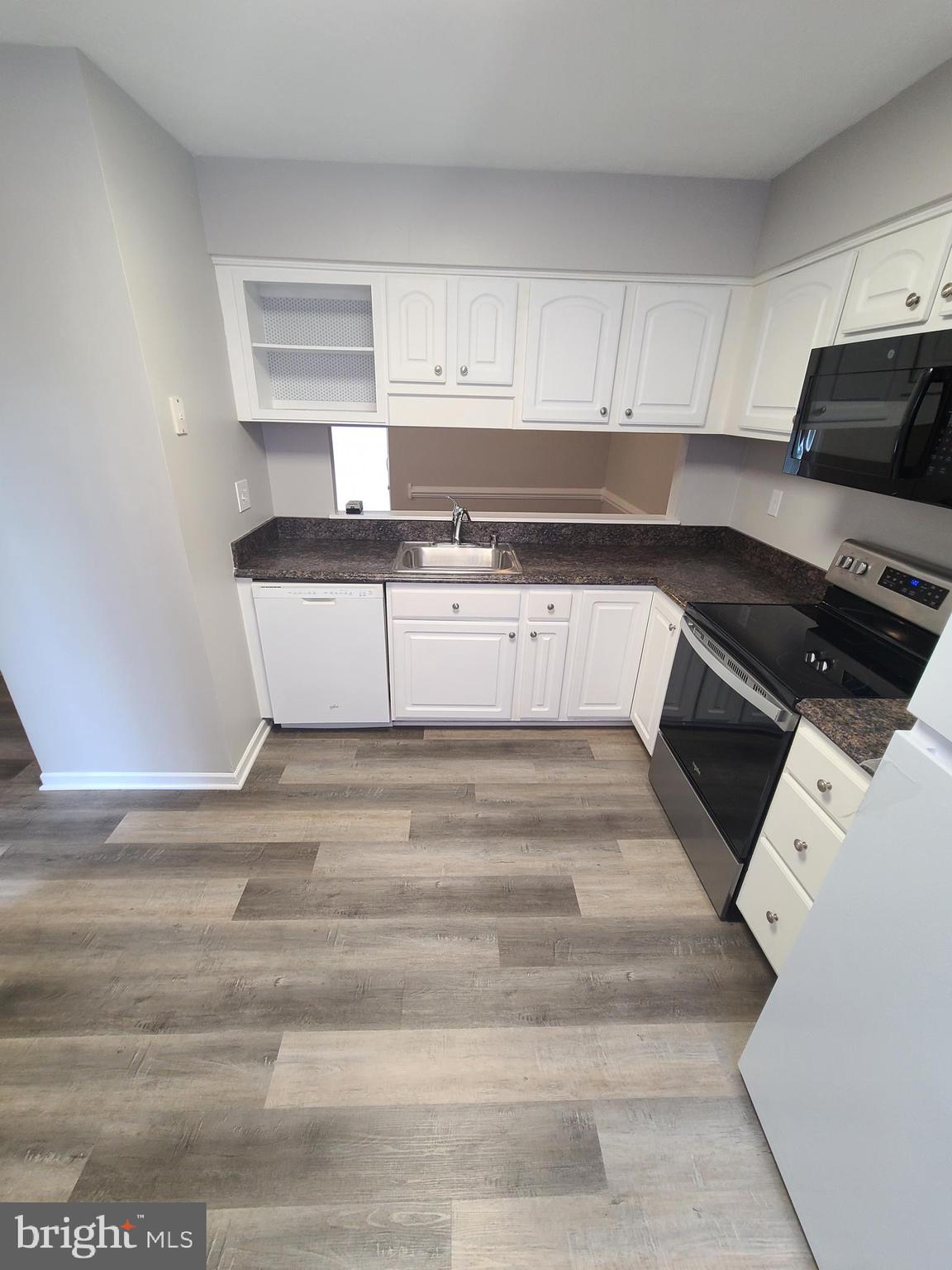 18042 Ohara Circle Olney, MD 20832 - Photo 6 of 35 a view of kitchen with granite countertop white cabinets and black appliances