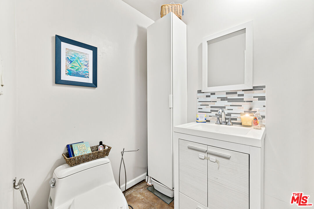 5139 Balboa Boulevard, Unit 9 Encino, CA 91316 - Photo 18 of 30 a bathroom with a toilet sink vanity and mirror