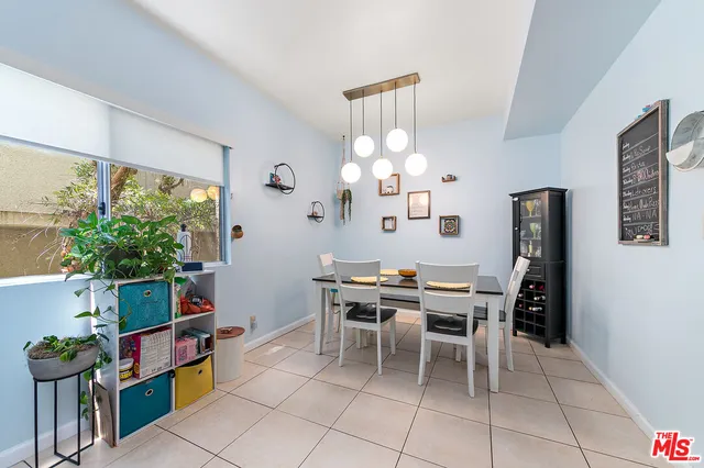 a view of a dining room with furniture and a potted plant