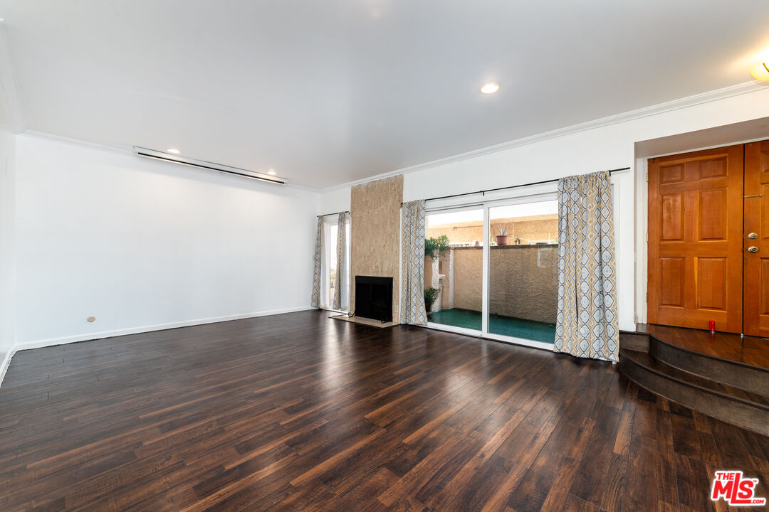 5139 Balboa Boulevard, Unit 9 Encino, CA 91316 - Photo 3 of 30 an empty room with wooden floor and windows