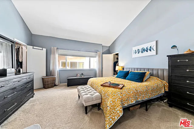 a bedroom with a bed and a couch