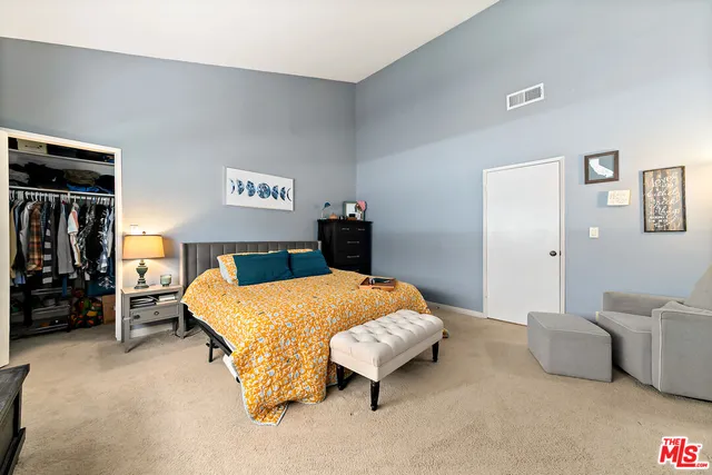 a bedroom with a bed and dresser