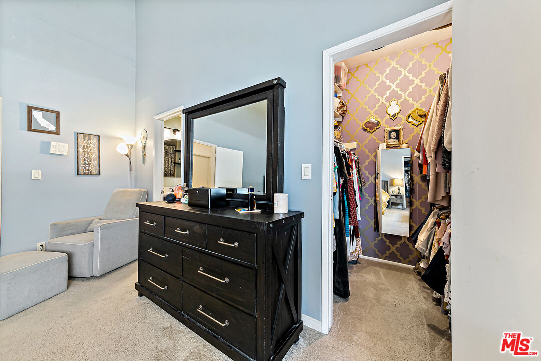 5139 Balboa Boulevard, Unit 9 Encino, CA 91316 - Photo 9 of 30 a room with a bed and a mirror on the dresser