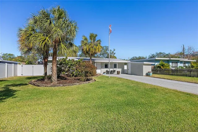 a view of a house with a yard and sitting area
