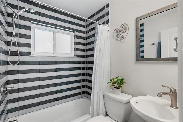 a white toilet sitting next to a bathroom sink