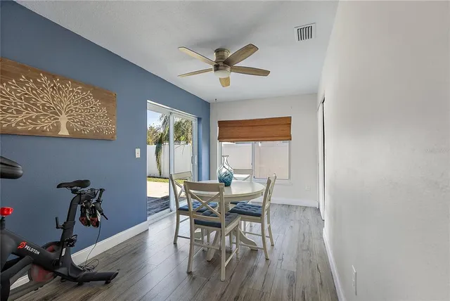 a dining room with furniture and wooden floor
