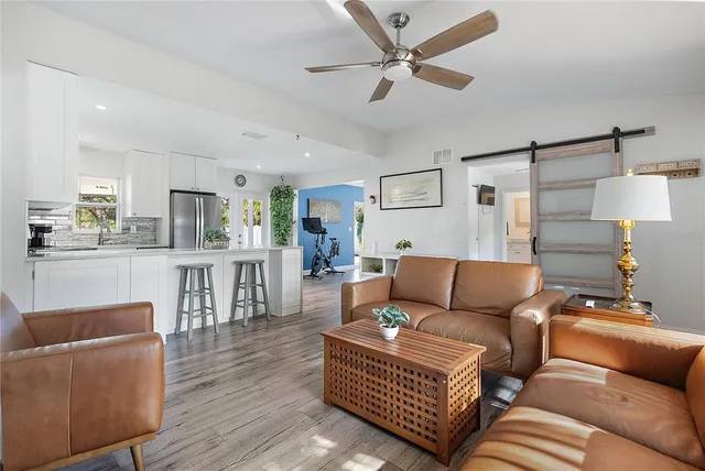 a living room with furniture and wooden floor