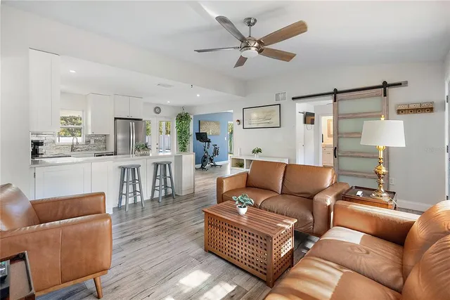 a living room with furniture and wooden floor