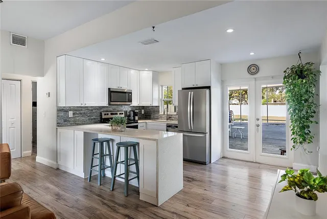 a kitchen with a refrigerator and a microwave
