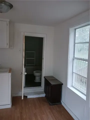 a room with wooden floor and window